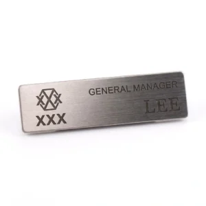 OEM custom gold brushed metal staff name badges for corporate uniforms, available in bulk for wholesale buyers